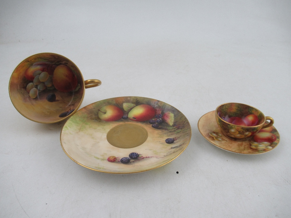 A Royal Worcester tea cup and saucer decorated with fruit by Austin and Price together with a