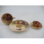 A Royal Worcester tea cup and saucer decorated with fruit by Austin and Price together with a