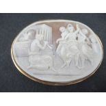 An oval carved cameo brooch, decorated with a Classical scene of the three Graces' dancing and a