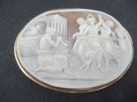 An oval carved cameo brooch, decorated with a Classical scene of the three Graces' dancing and a