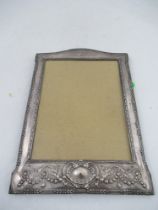 A silver mounted photograph frame, of rectangular form with embossed decoration, Birmingham, 1921,