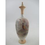 A Royal Worcester covered vase decorated with a cock pheasant in a glade by James Stinton shape No