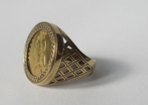 A 9ct ring set with a Victorian shield back half sovereign, dated 1892, with pierced shoulders,