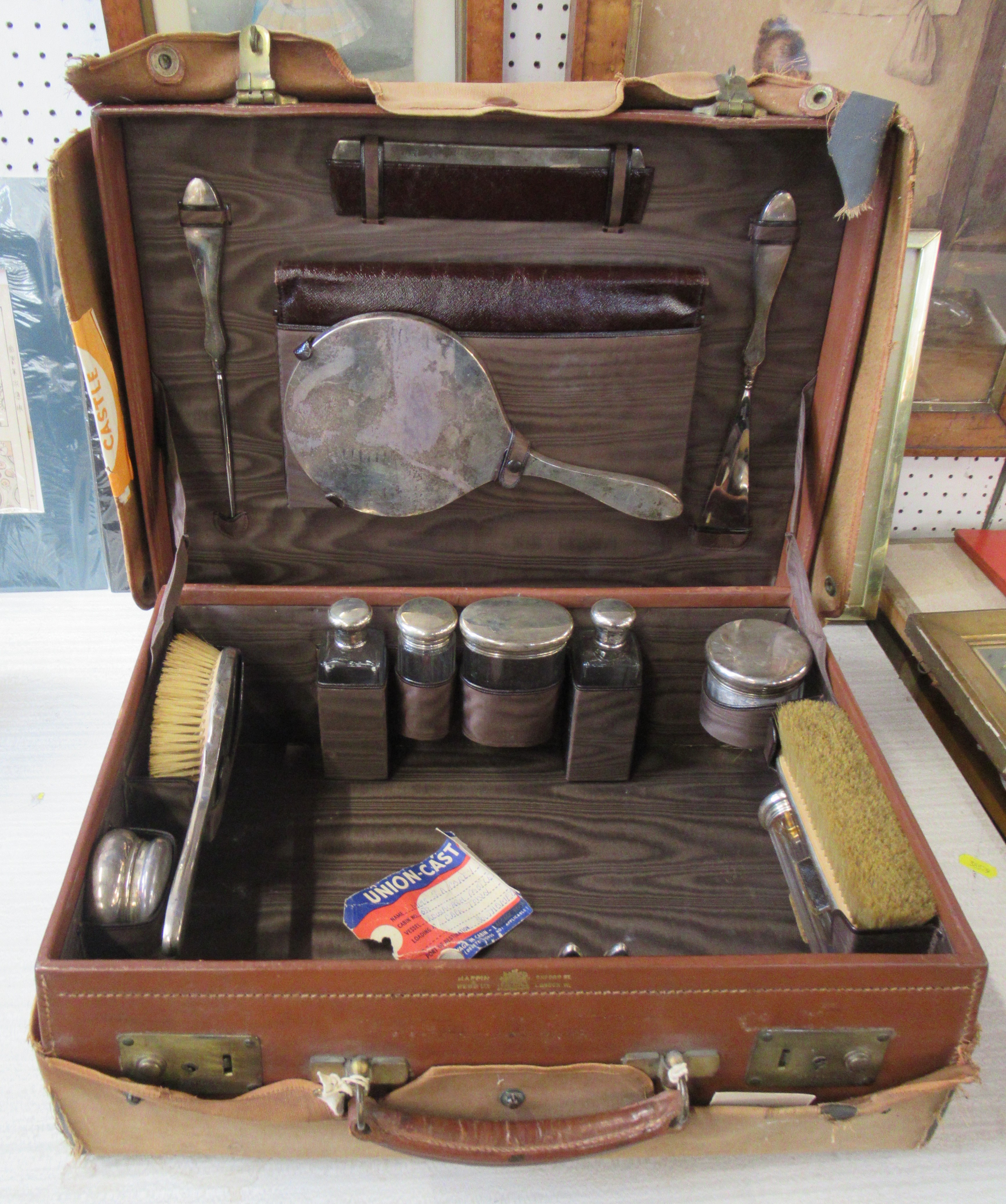 A Mappin & Webb leather fitted travel case, with canvas cover, fitted with various silver backed