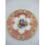 A Royal Worcester plate decorated with damsons and gooseberries to a pink gilt richly enameled