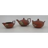 A 19th century Wedgwood terracotta three piece tea set, decorated with flowers Condition Report: All