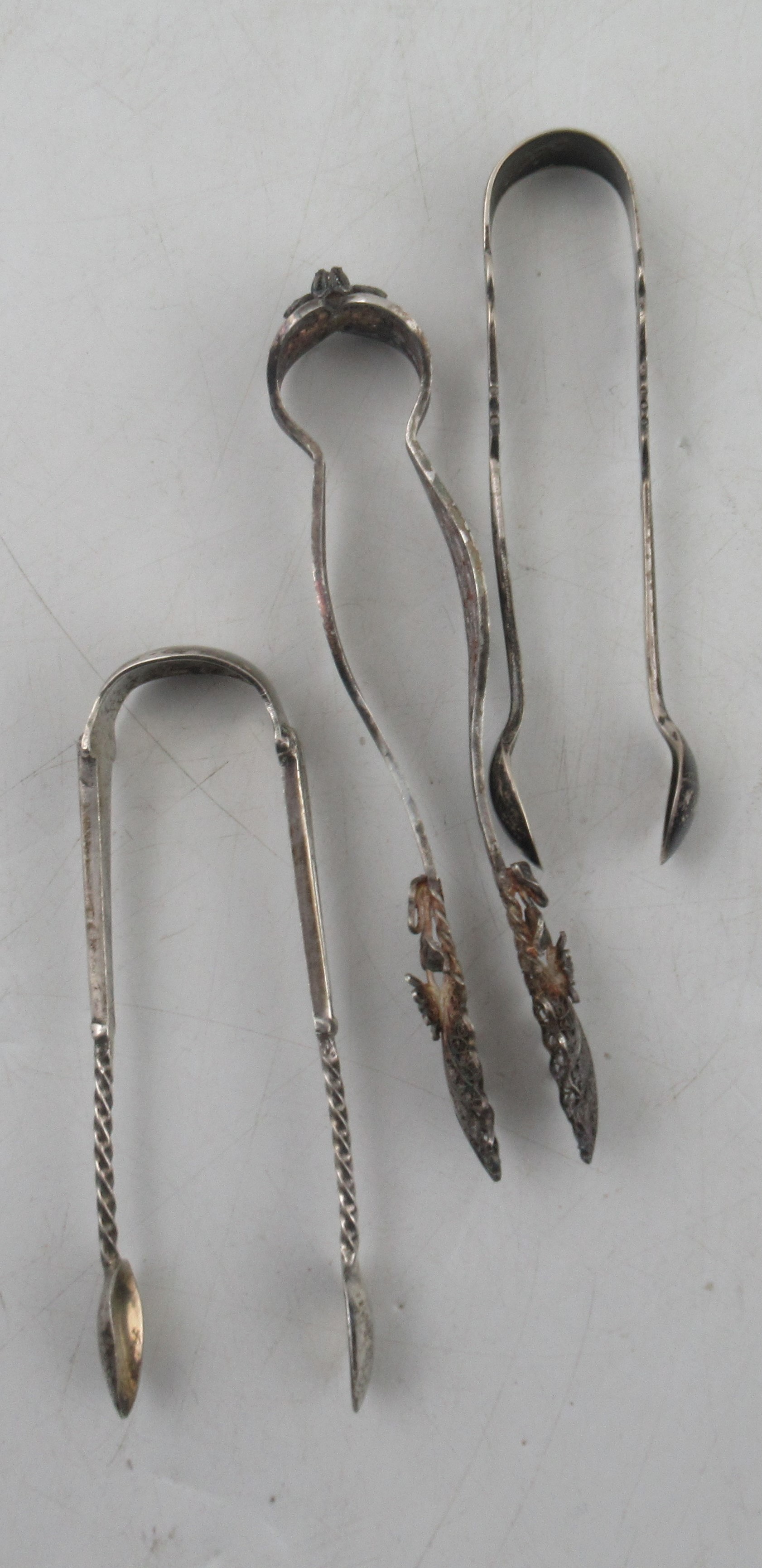 A Scottish silver fiddle pattern sauce ladle, together with three sugar tongs and a butter knife, - Image 2 of 4