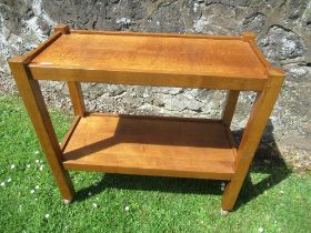 An Arts and Crafts oak tea trolley, carved with a cat, 34ins x 16ins