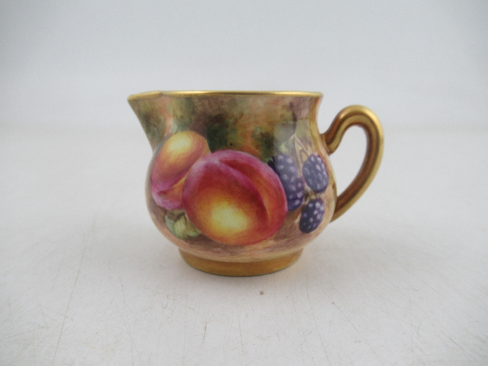 A Royal Worcester miniature milk jug decorated with Fruit by Freeman height approx 1.25ins Condition