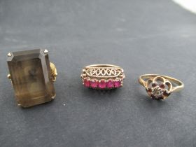 A yellow gold five stone ruby ring, in basket mount, unmarked, a gold ring set with an emerald cut