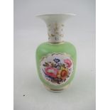 A Chamberlains Worcester vase decorated with a reserved panel of flowers to an apple green ground,