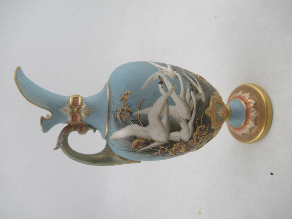 A Royal Worcester  ewer decorated with swans to a powder blue ground by CHC Baldwyn height 8.5ins