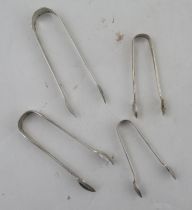 A pair of Georgian silver bright cut sugar tongs, together with three other pairs of sugar tongs,
