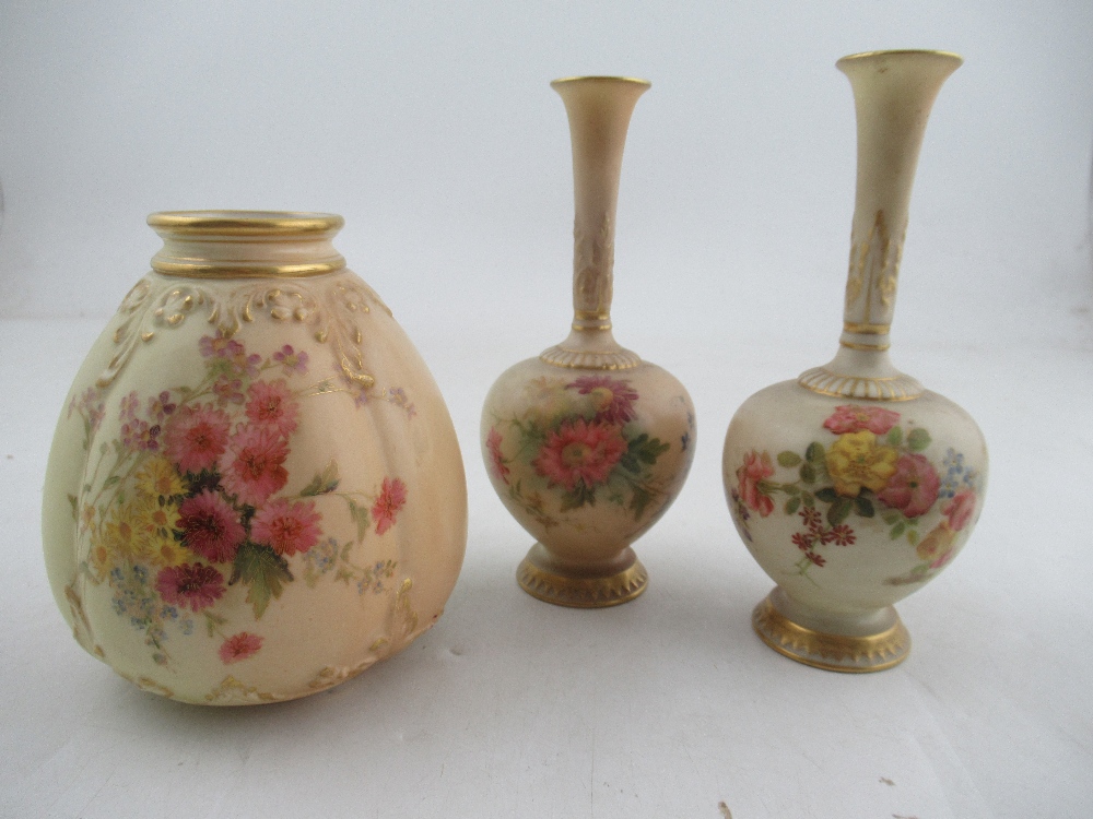 A pair of Royal Worcester blush ivory vases decorated with flowers together with a Royal Worcester