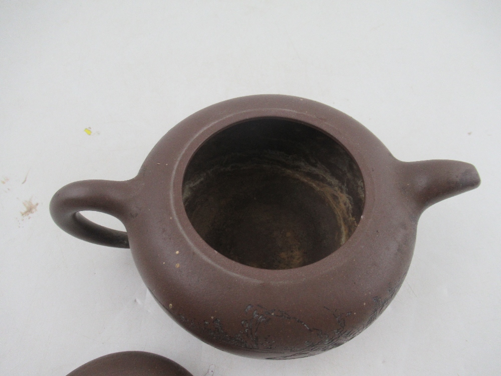 A Chinese Yixing style terracotta teapot, incised with a landscape and script, with seal mark, - Bild 2 aus 5