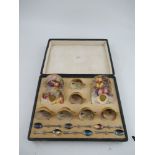 A Royal Worcester cased set of 6 miniature tea cups and saucers decorated with hand painted fruit