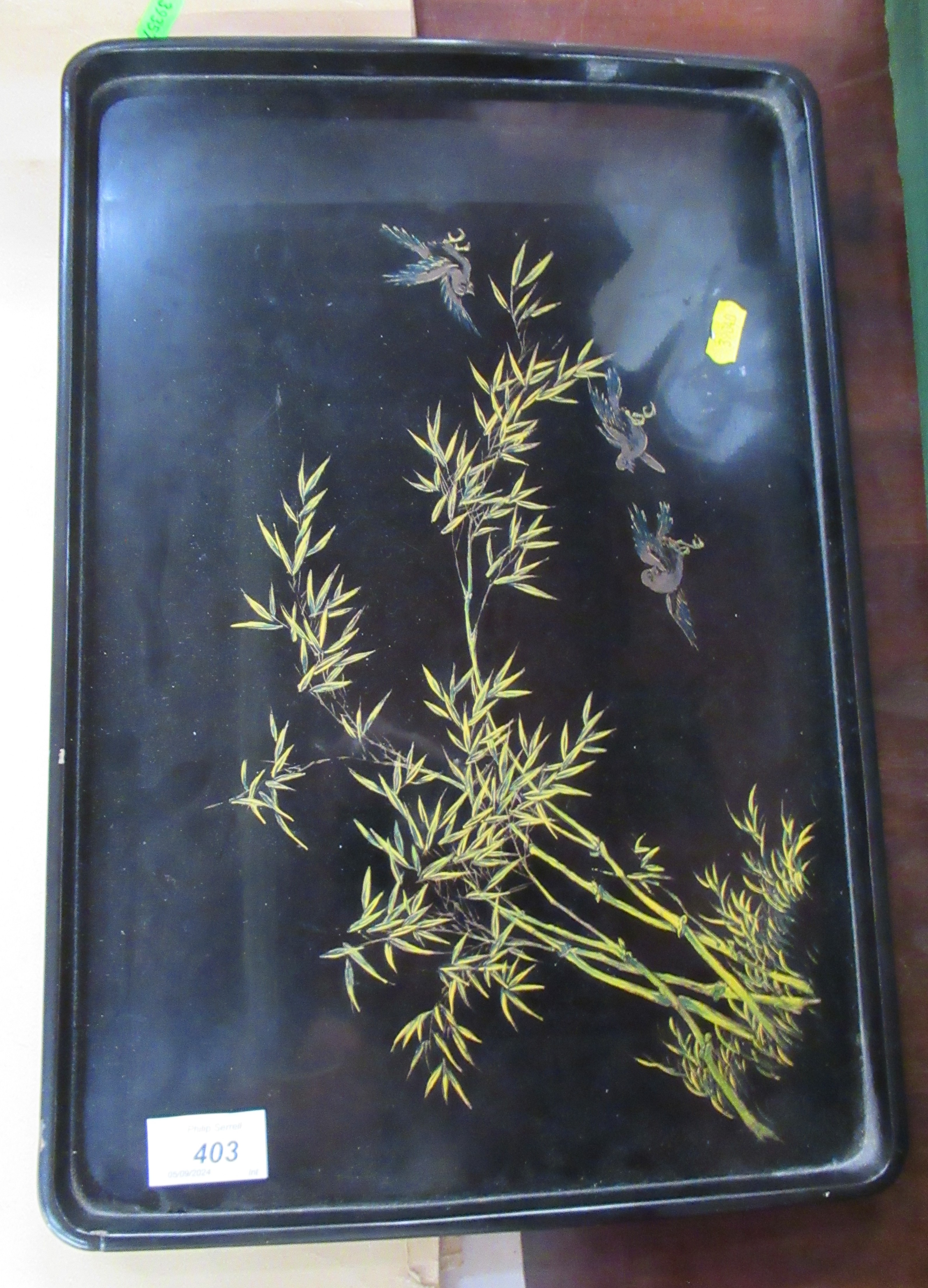 A Chinese lacquered tray decorated with foliage and birds