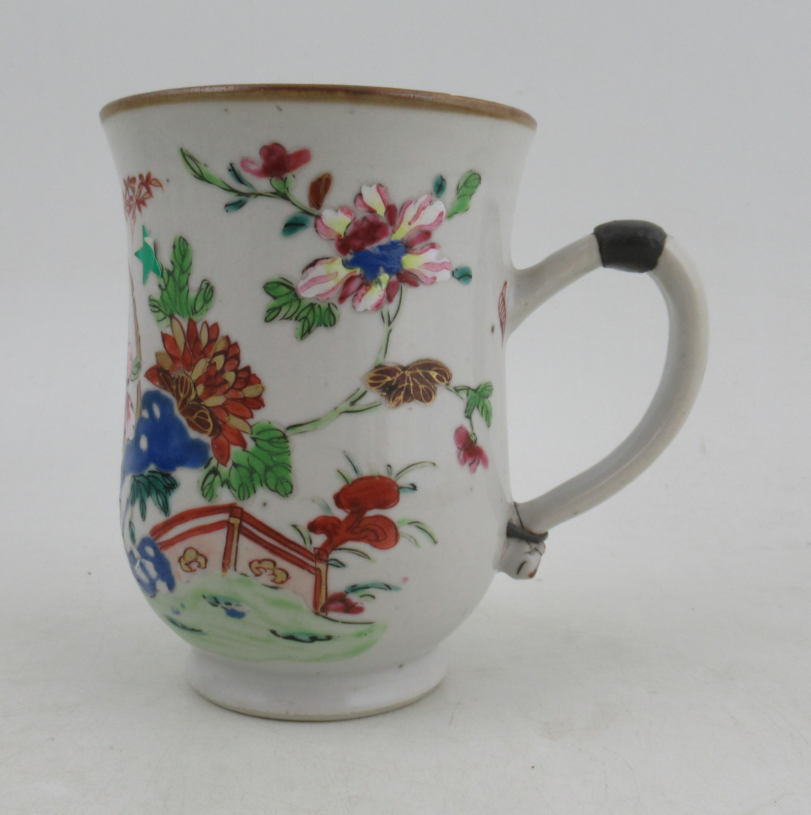 An Oriental tankard, with floral decoration, metal bands to handle, height 5.5ins