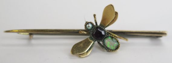 An Antique Opal, Garnet and untested Pearl Insect Brooch on an unmarked precious yellow metal mount,