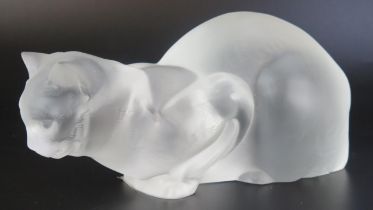 A Lalique frosted glass model of a crouching cat, engraved Lalique, France to the base, 23cm long.