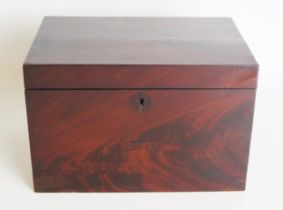 A 19th century mahogany tea caddy, of rectangular outline, the hinged lid enclosing a glass