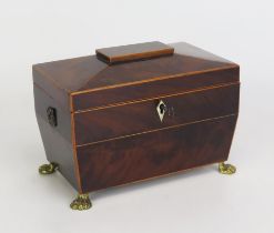 A Georgian mahogany and boxwood strung tea caddy of sarcophagus outline, the shallow domed hinged