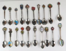 A collection of silver plated and enamel souvenir and other spoons.
