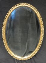 A gilt plaster framed oval wall mirror, 81 x 55cm