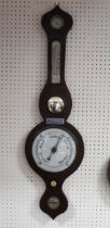 A Victorian mahogany onion topped wheel barometer, fitted with hygrometer, mercurial thermometer,