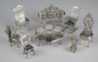 A collection of miniature furniture, various makers and dates includes two sofas and six assorted