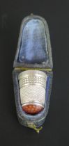 An Edward VII silver and agate thimble, maker Charles Horner, Chester, 1907, contained in a