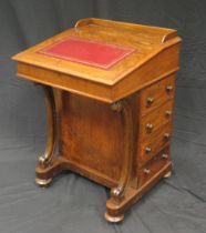 A Victorian rosewood davenport, the sloping hinged fall with inset tooled leather writing surface,