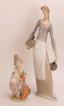A Nao porcelain figure of a female water carrier holding two pitchers, 39cm high, together with a