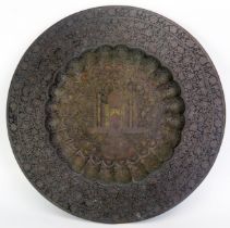 An Indian brass circular dish, with lobed centre decorated with the Taj Mahal, the rim with banded