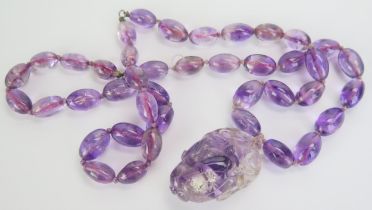 A Chinese Caved Amethyst Pendant (44.8mm drop) and on an oval bead necklace, c. 29" (74cm), 125.17g