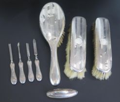 A collection of silver mounted dressing table wares, includes hair brush, two clothes brushes, and