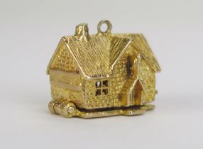 A 9ct Gold "The Hunter's Inn" Articulated Charm, opening to reveal a tavern scene, hallmarked, 6.18g