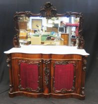 A Victorian rosewood sideboard, with an arched mirror back with foliate crest, the double serpentine