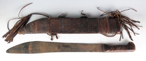 An African (possibly Yoruba) hacking knife, with 45cm single edge blade, wood and leather bound