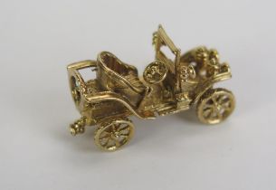 A 9ct Gold Classic Car Charm with articulated wheels, hallmarked, 5.14g
