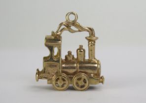 A 9ct Gold Steam Train Charm with articulated wheels, hallmarked, 5.8g