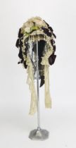A Victorian maroon velvet bonnet with black and white lace edging with applied simulated pearl