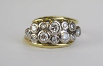 A Modern 18ct and Diamond Ring set with twelve brilliant round cut stones in a rub over precious