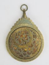 An Arabic Brass Circular Astrolabe with Arabic Script and Islamic Decoration, with four double-sided