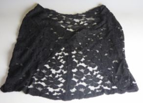 A 20th century black corded lace cocktail shawl, of floral design.
