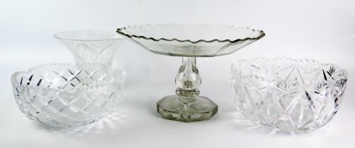 A clear glass tazza with wavy edge border, raised on an octagonal foot, two cut glass bowls, and a