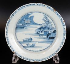 A Delft blue and white plate, with landscape decoration, 22cm diameter, a/f.