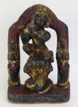 An Indian carved hardstone and polychrome decorated figure of Krishna with flute and kneeling on