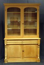 A Victorian stripped pine kitchen dresser, The upper part with a moulded cornice and a pair of