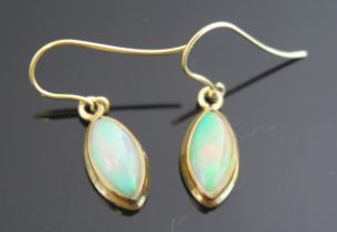 A Pair of White Fire Opal Pendant Earrings in a silver gilt setting, 27.6mm overall drop, singlet